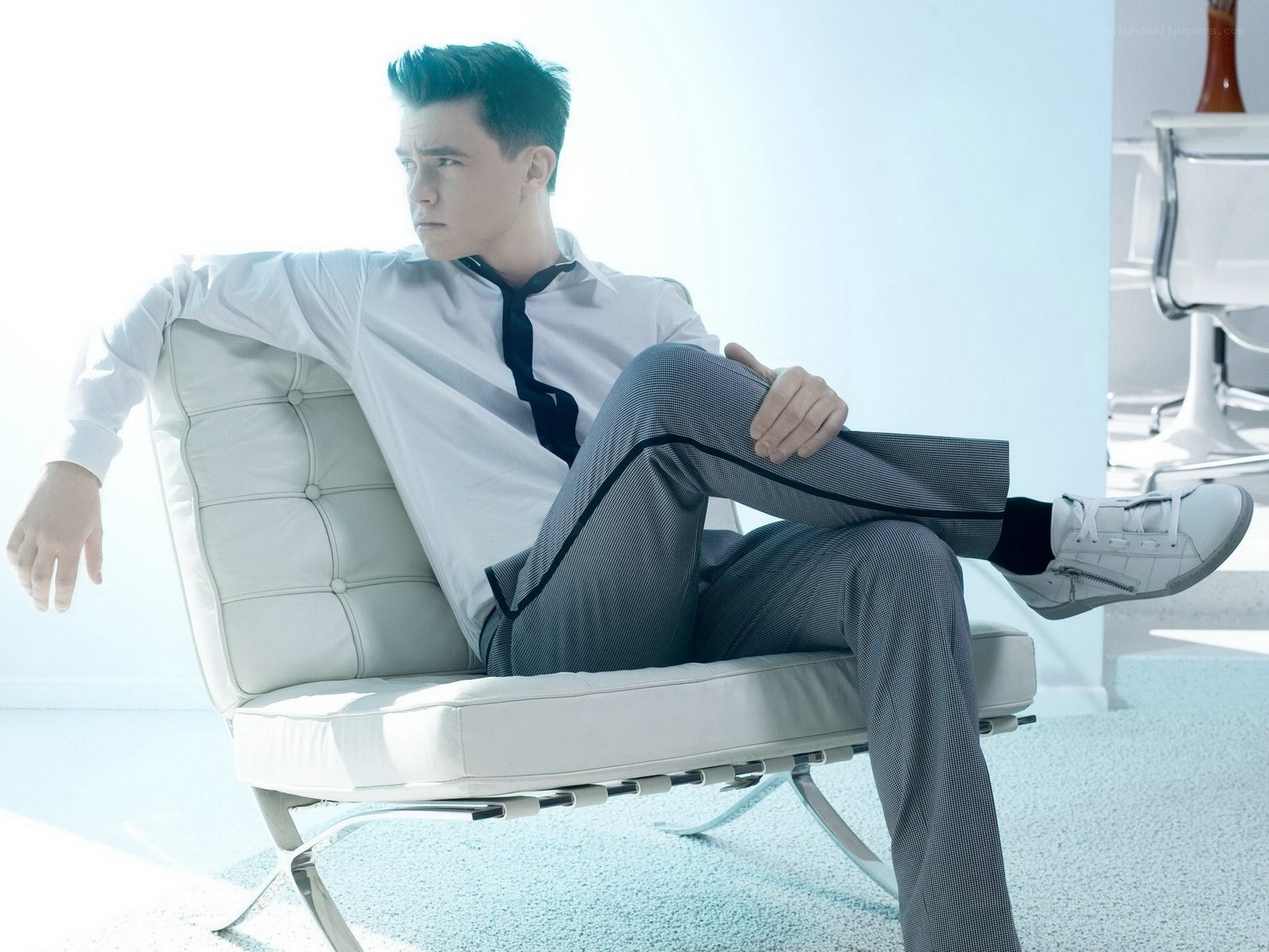 man in white shirt sitting