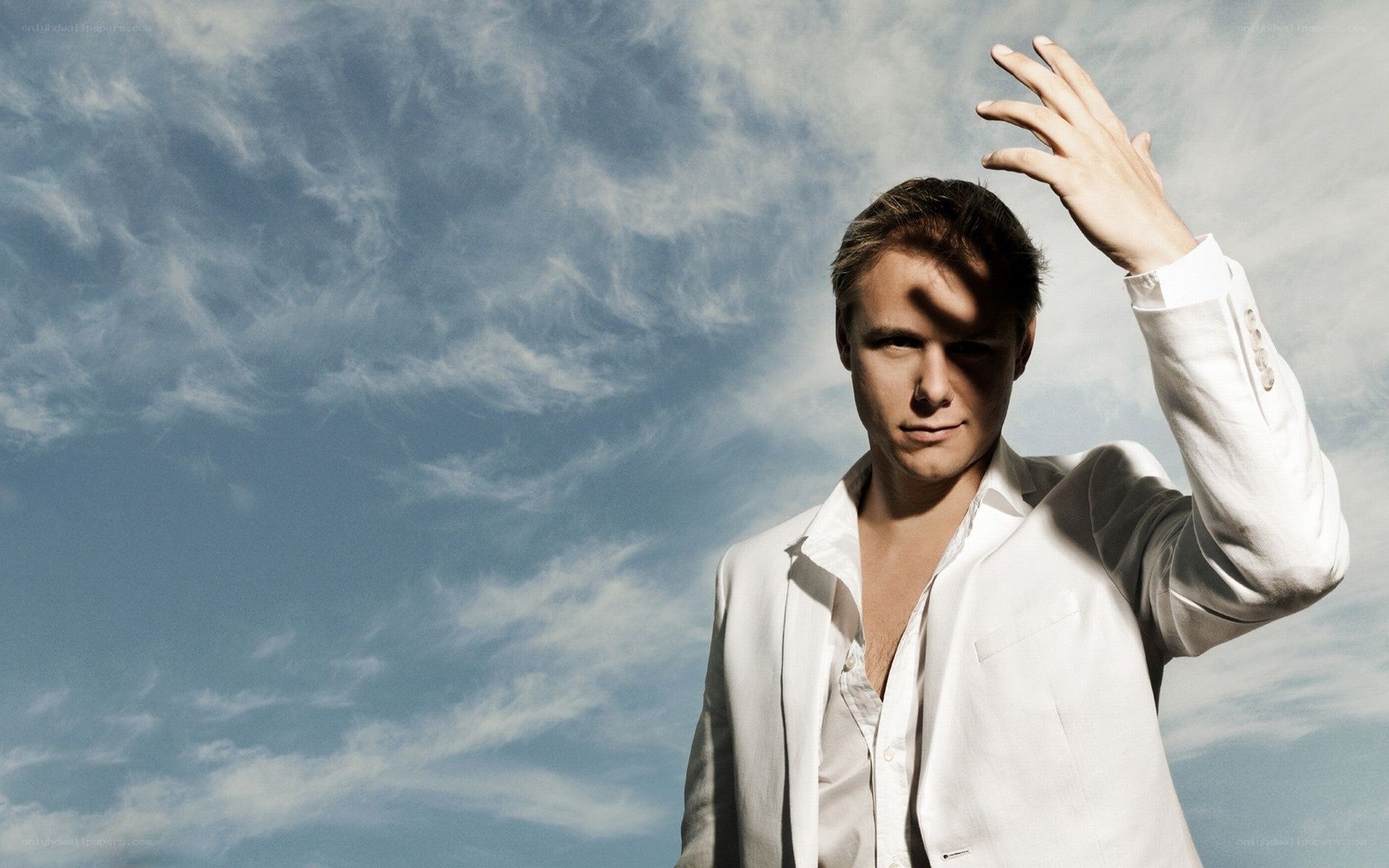 man in white suit against sky