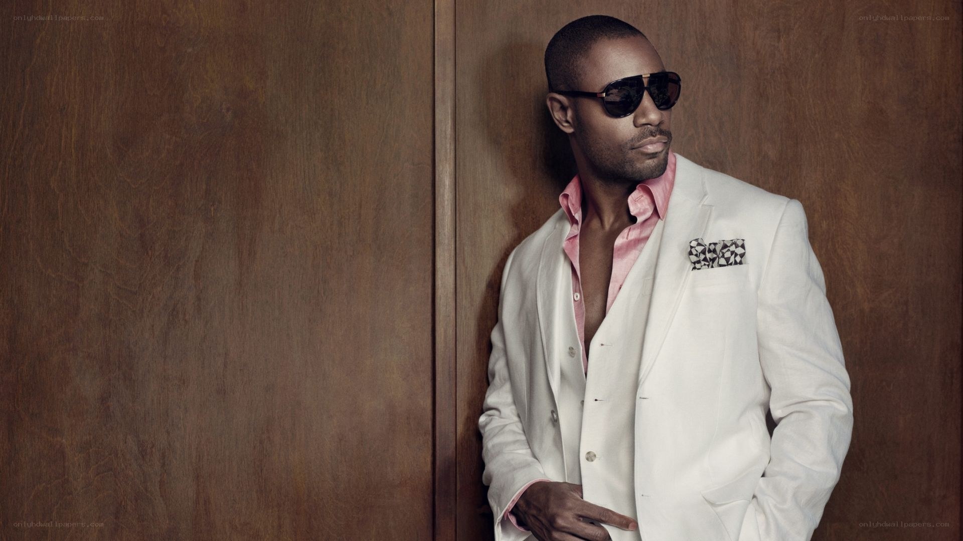 man in white suit and sunglasses