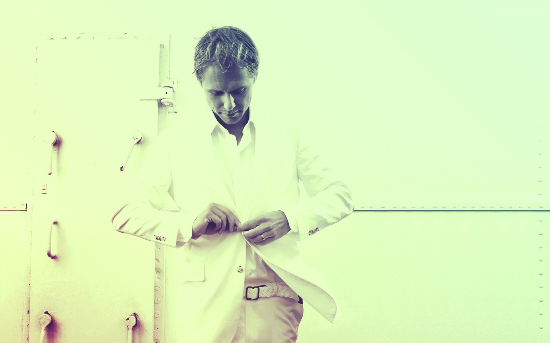 man in white suit buttoning jacket
