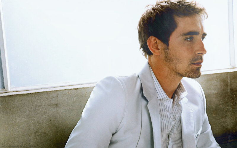 man in white suit by window