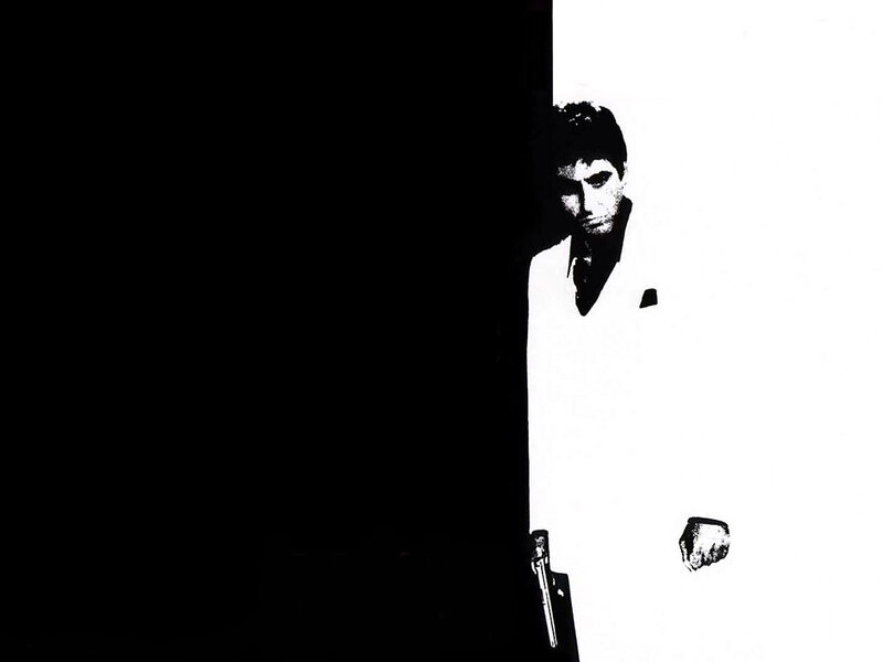 Man in white suit holding gun