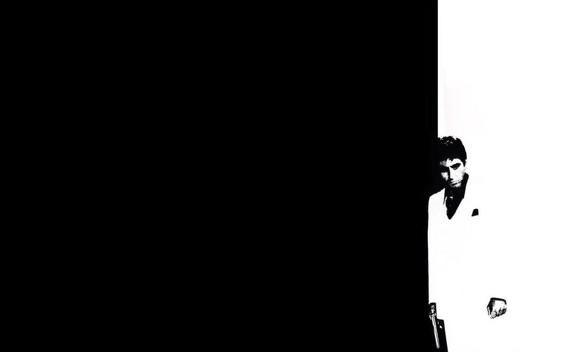 man in white suit holding gun