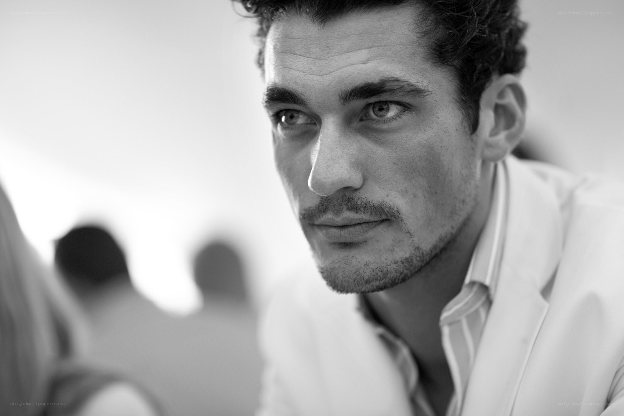 man in white suit looking away