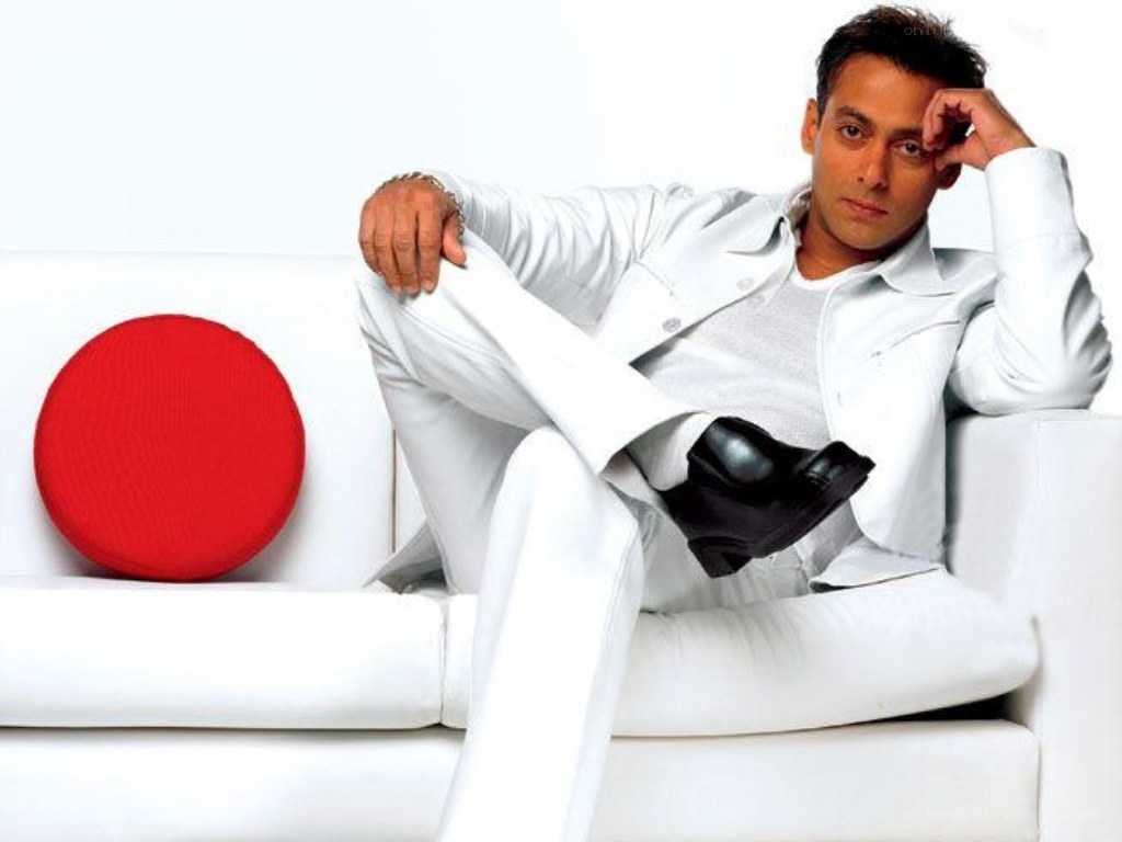 man in white suit on sofa
