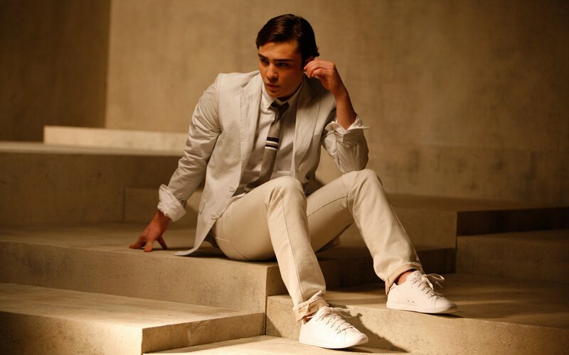 man in white suit on steps