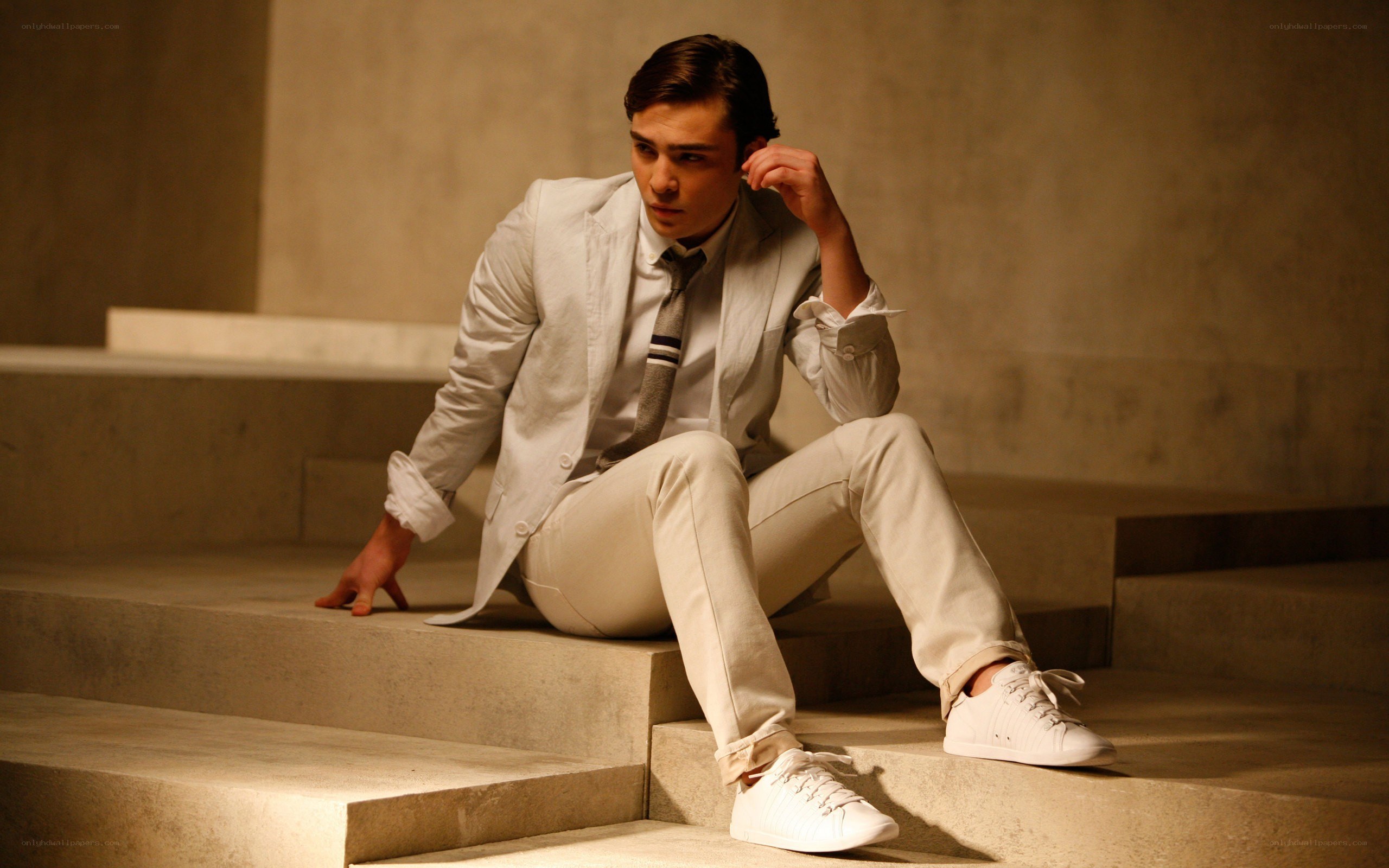 man in white suit on steps