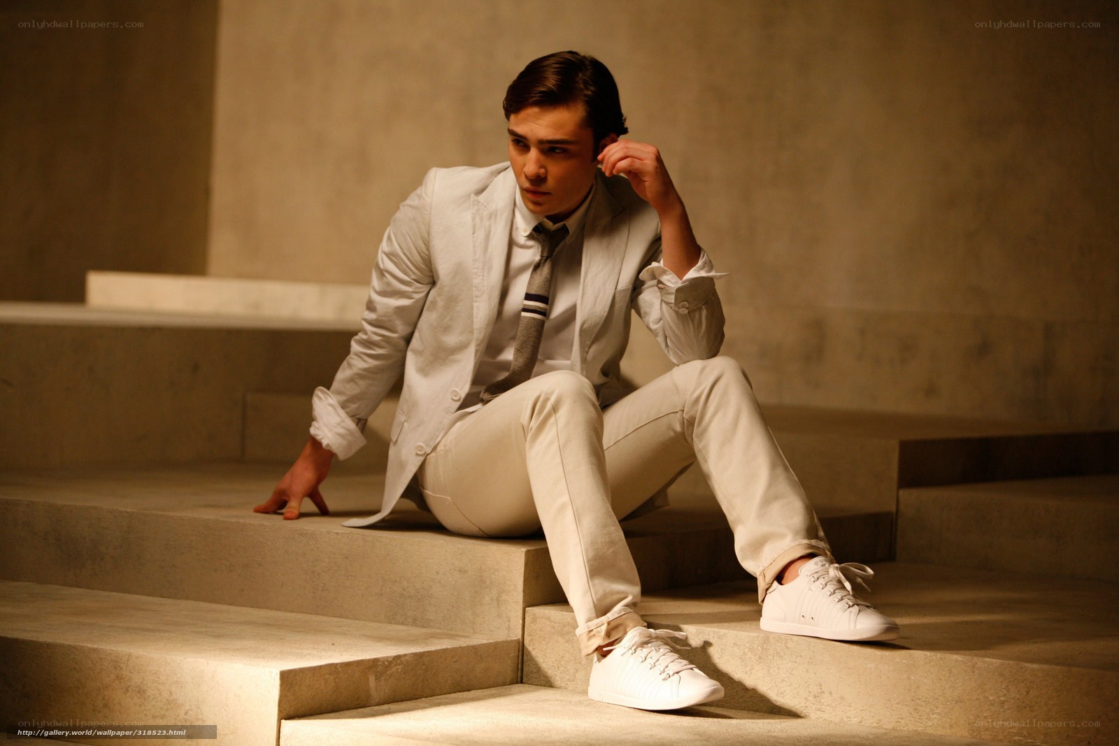 man in white suit on steps