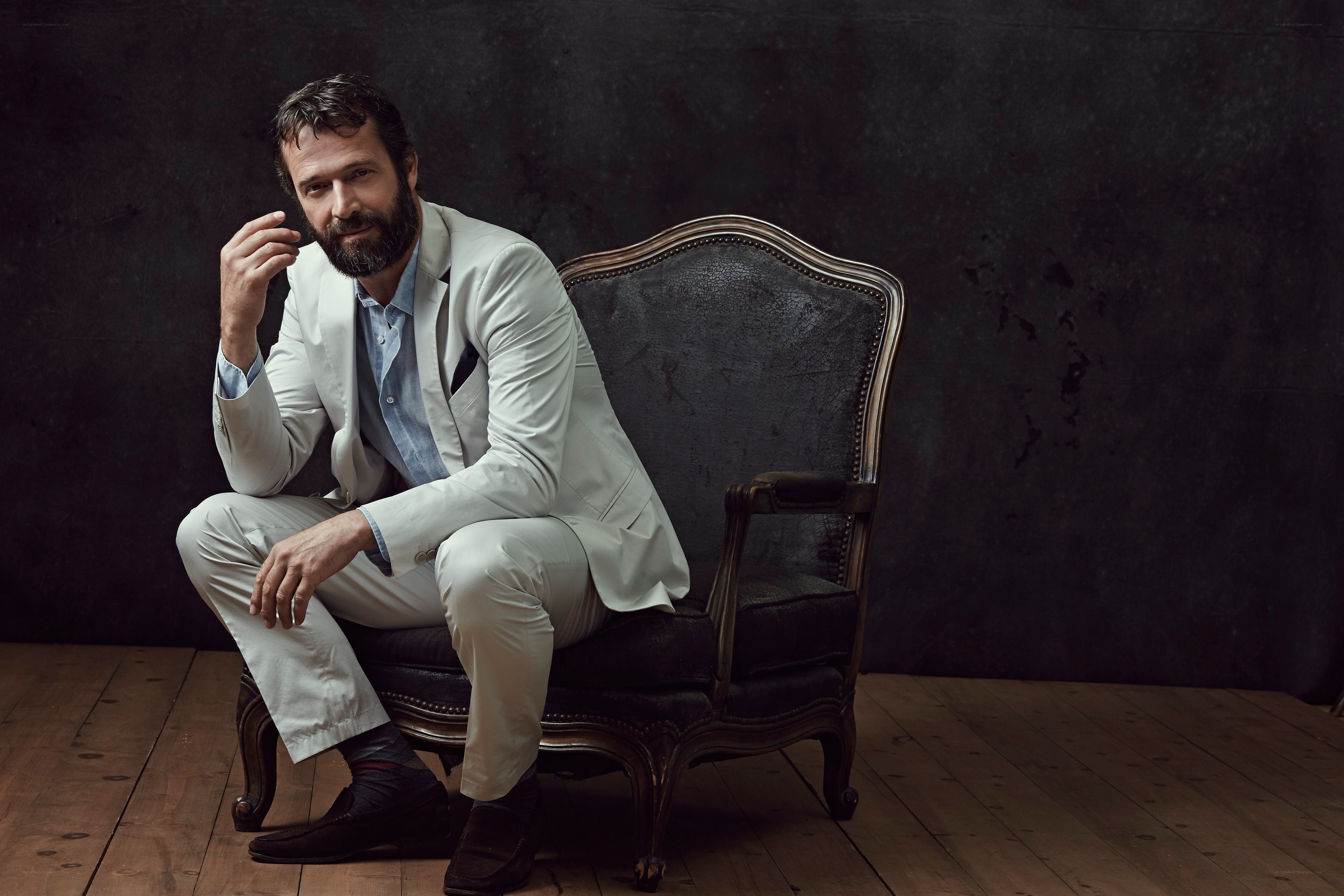 man in white suit sitting