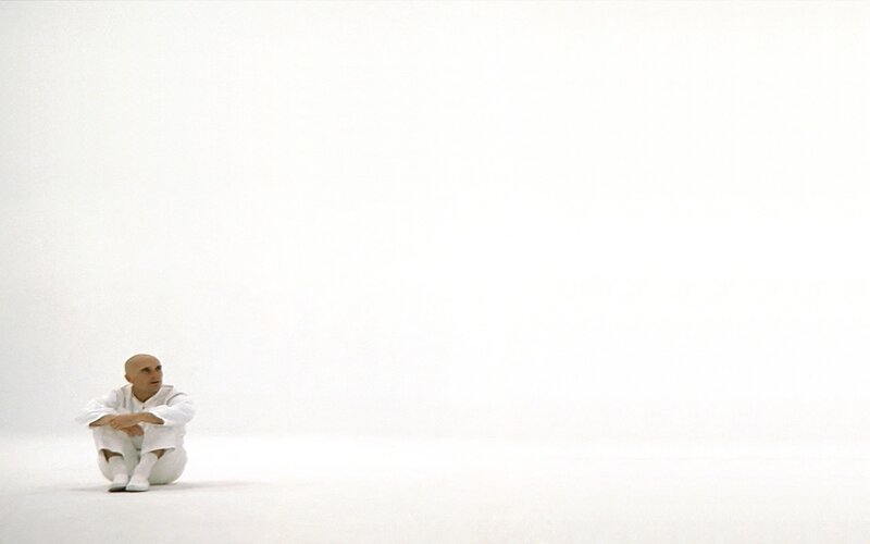 man in white suit sitting