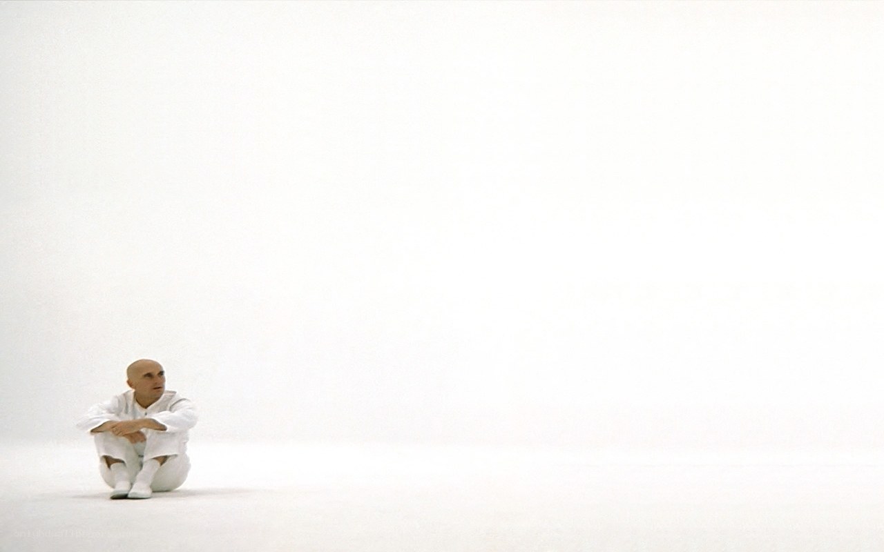 man in white suit sitting