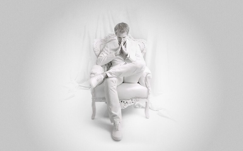 man in white suit sitting