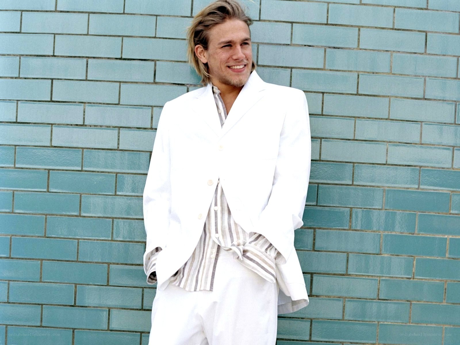 man in white suit smiling