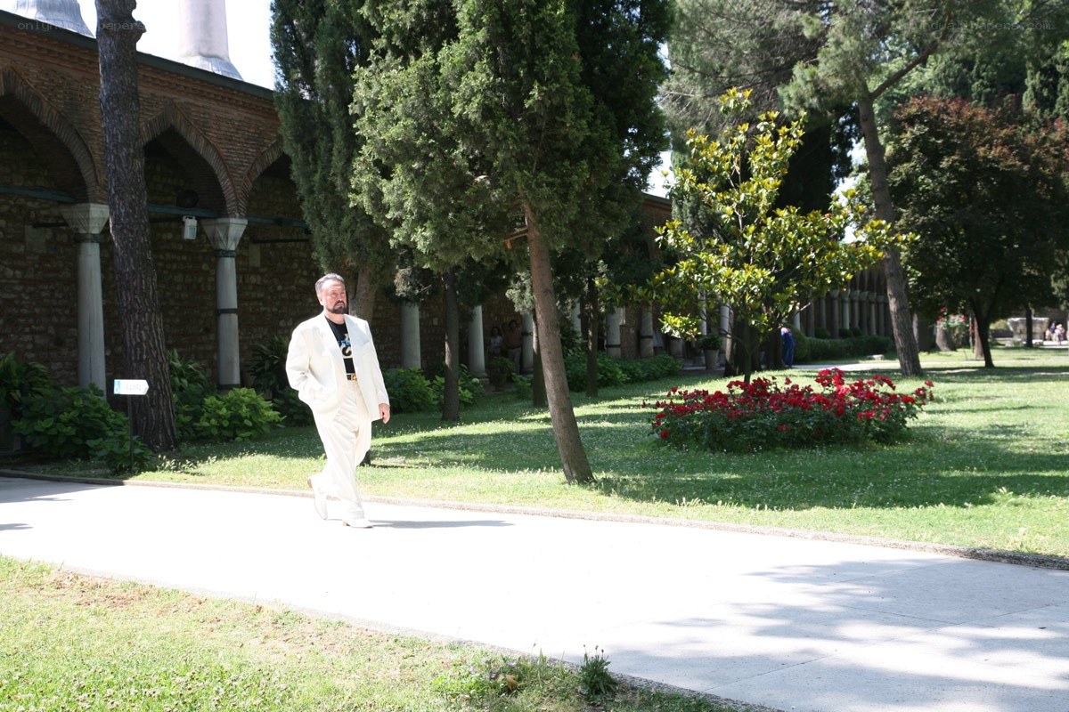 Man in white suit walking