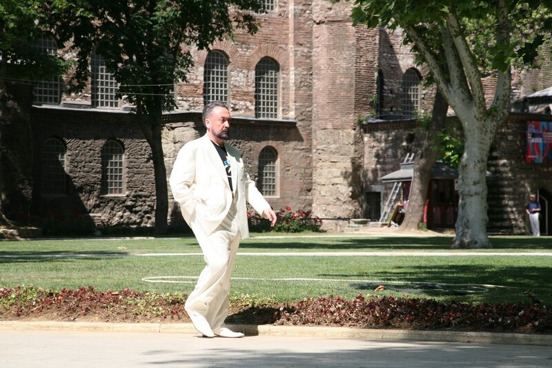 Man in white suit walking