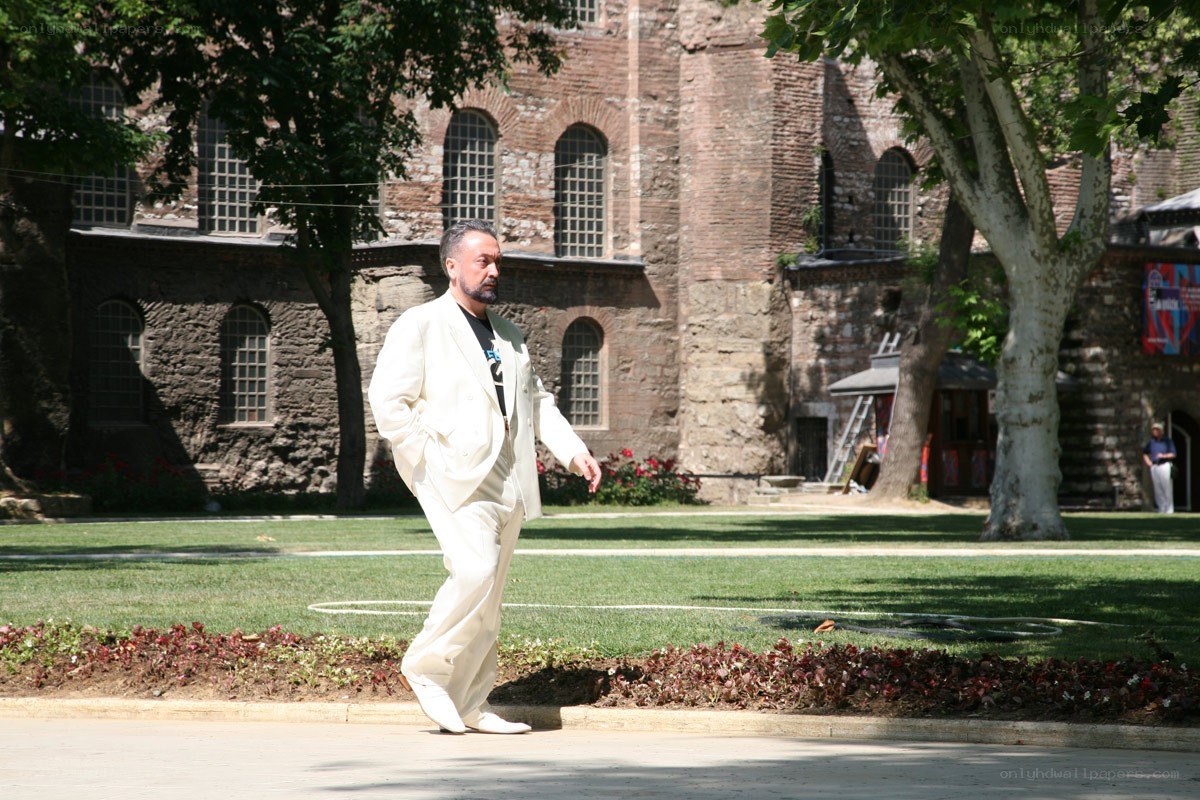 Man in white suit walking