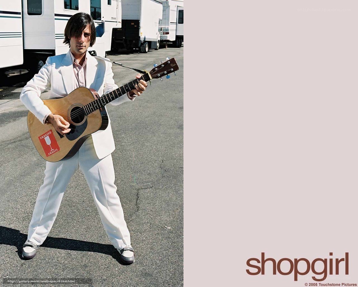 man in white suit with guitar
