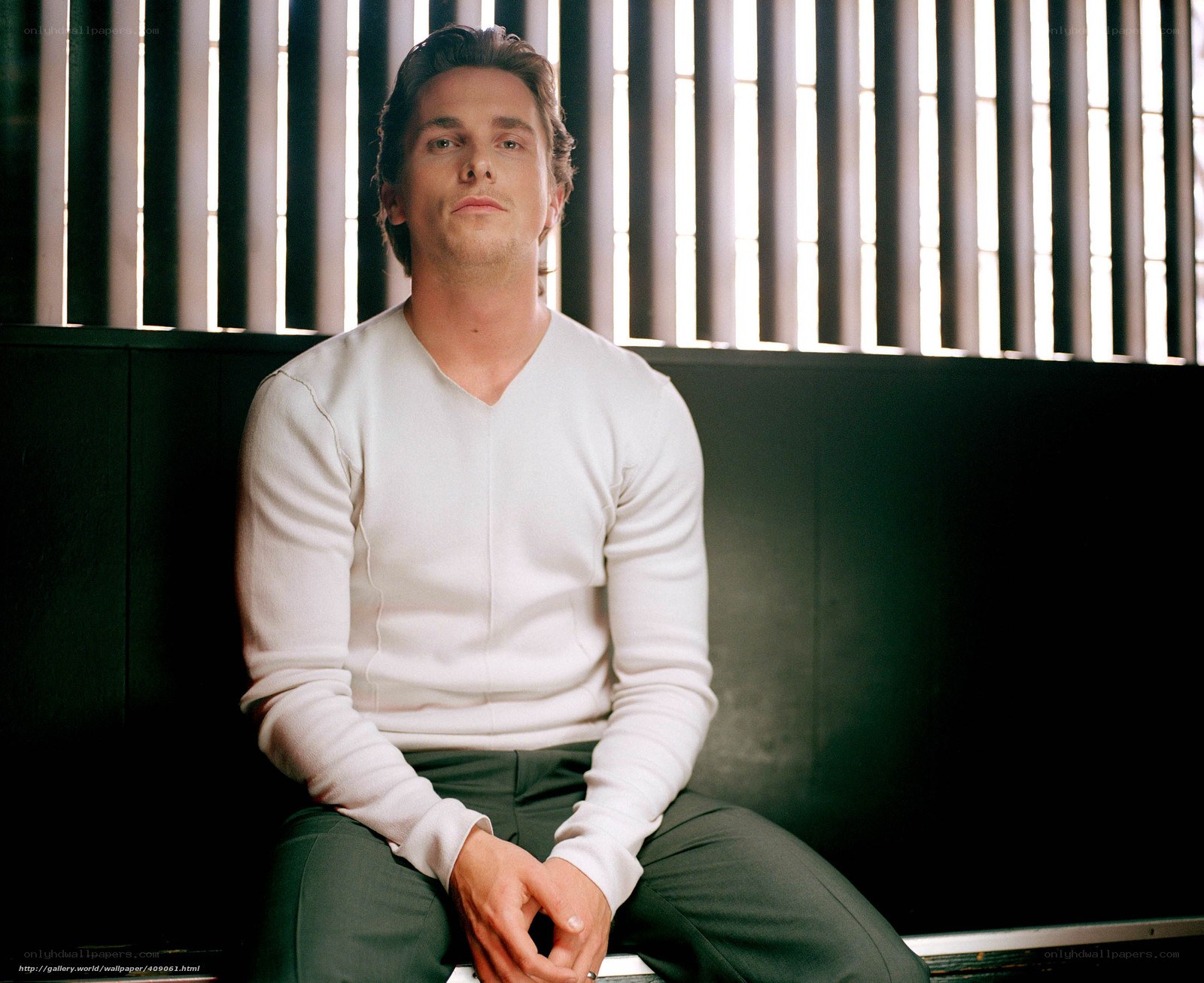 man in white sweater sitting