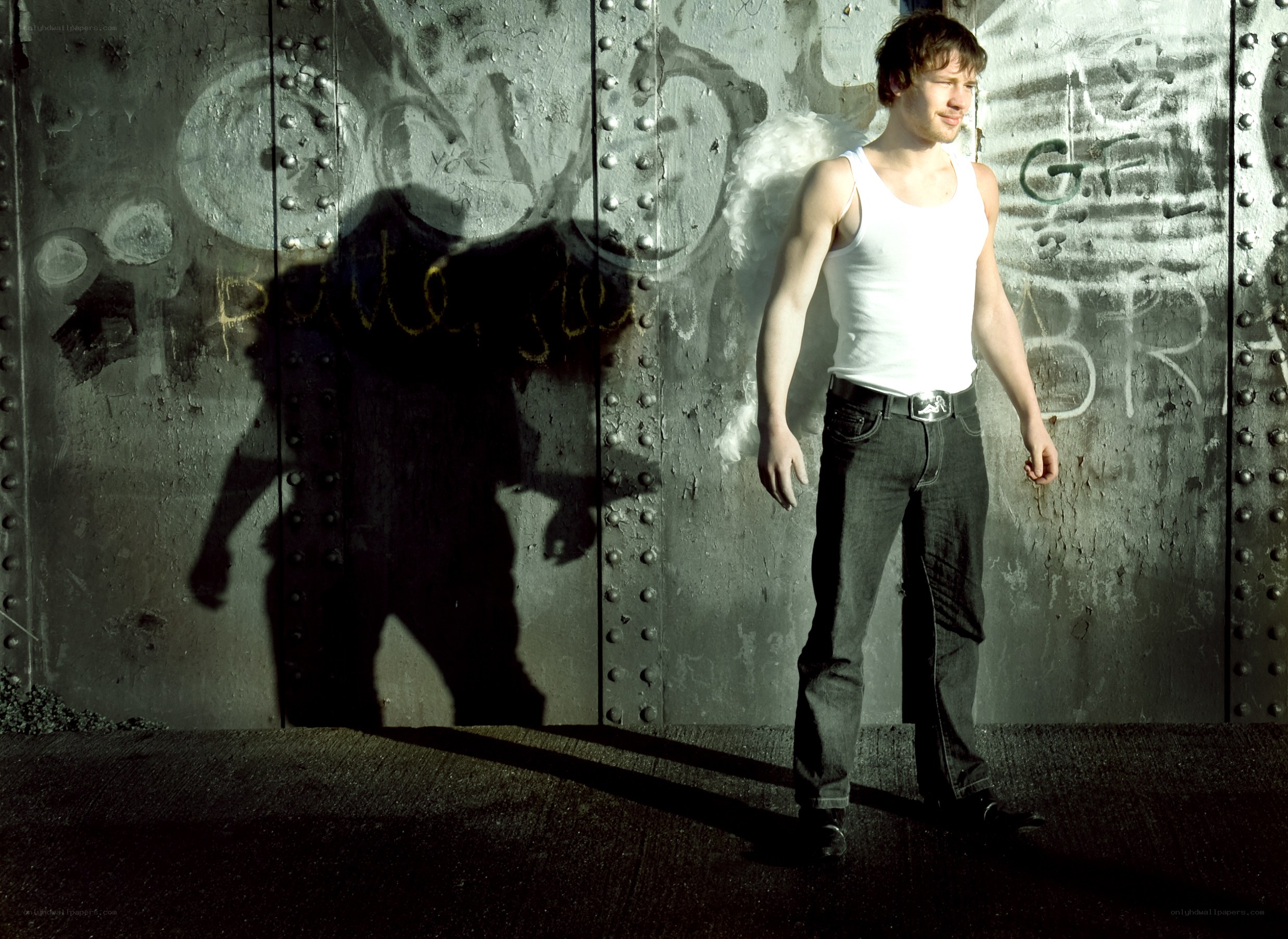 man in white tank top standing