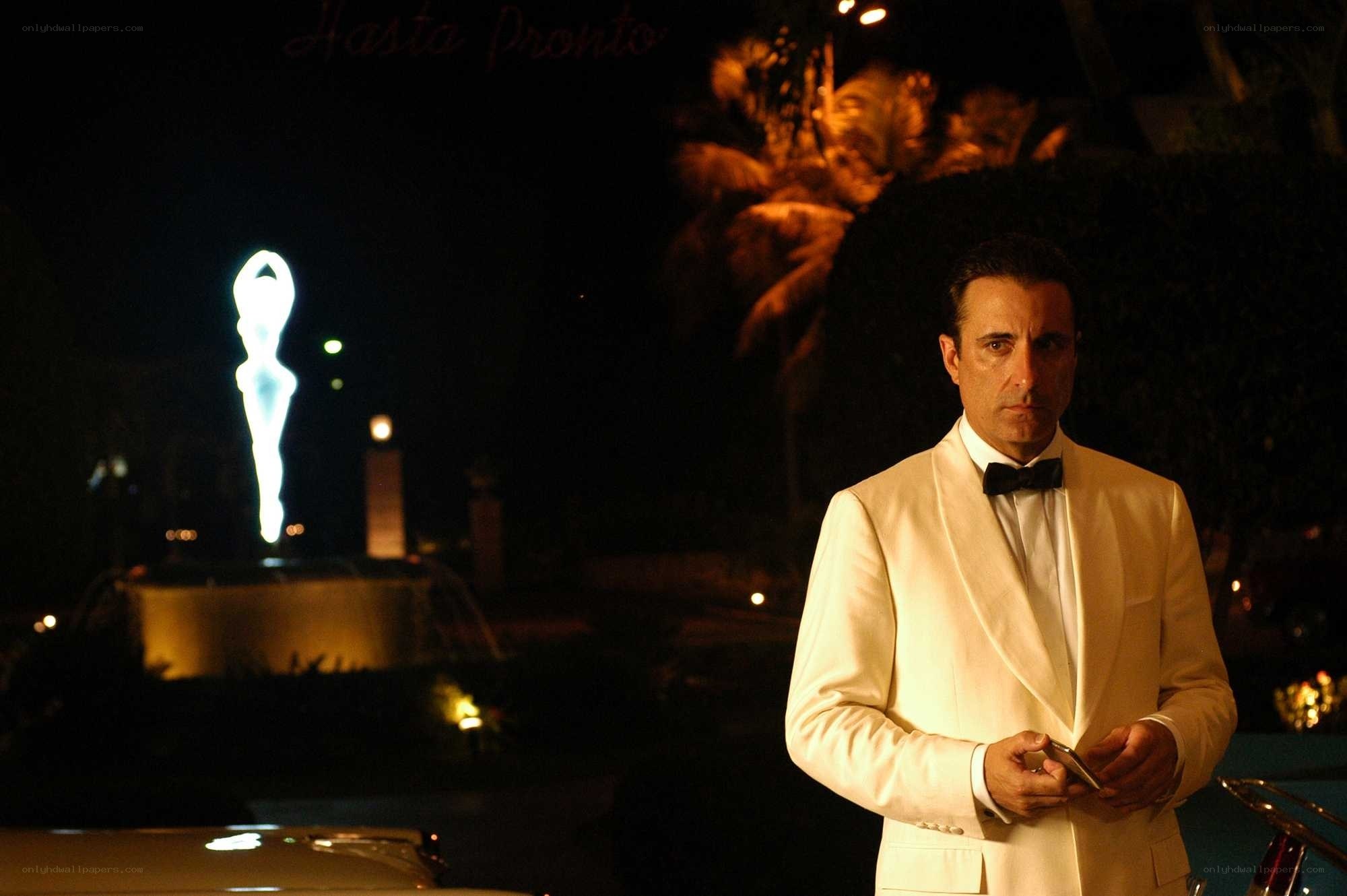 Man in white tuxedo at night