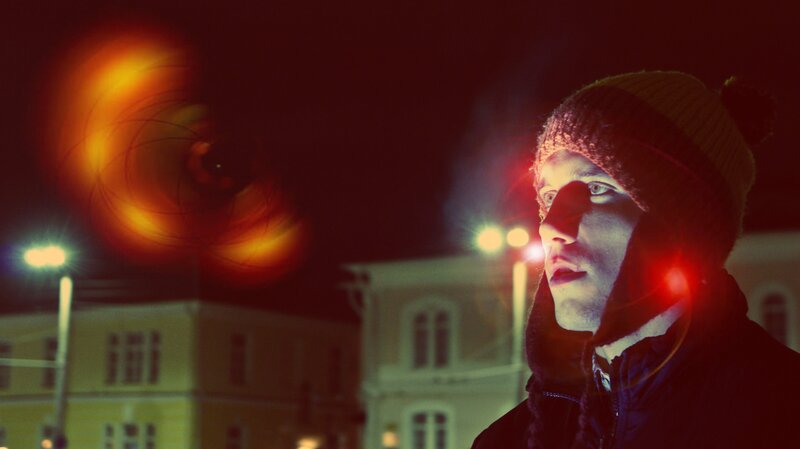 man in winter hat at night