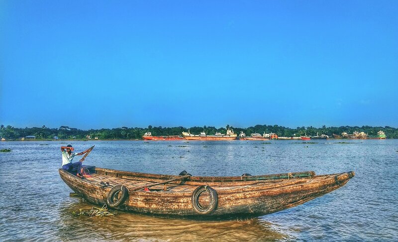 Man in Wooden Boat