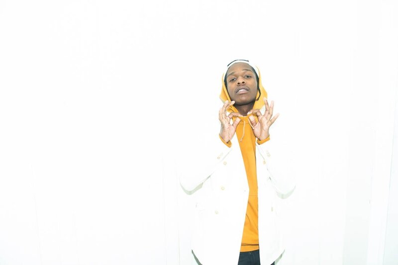 man in yellow hoodie and white coat