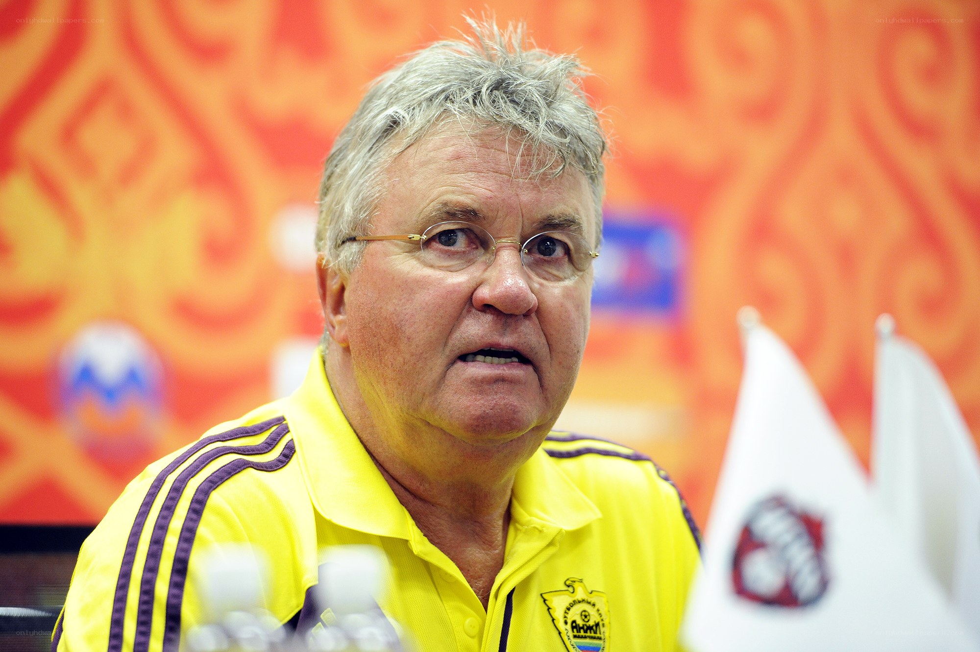 man in yellow shirt at press conference
