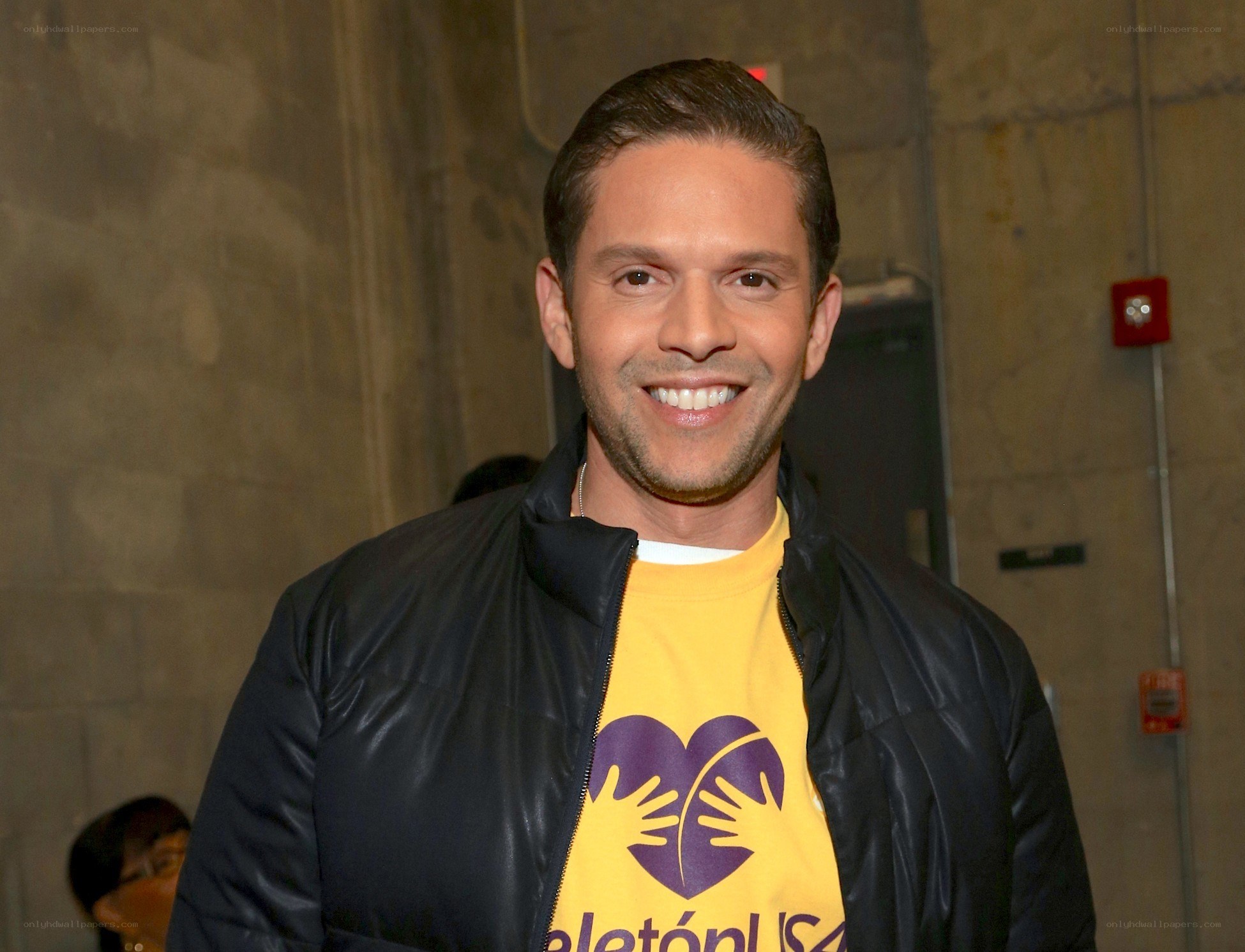 man in yellow t-shirt smiling