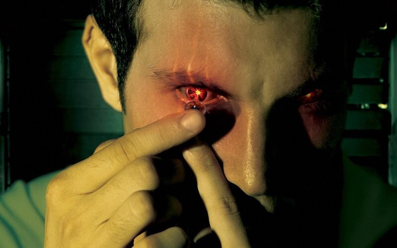 man inserting contact lens
