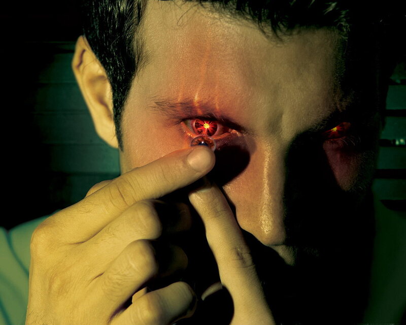 man inserting contact lens