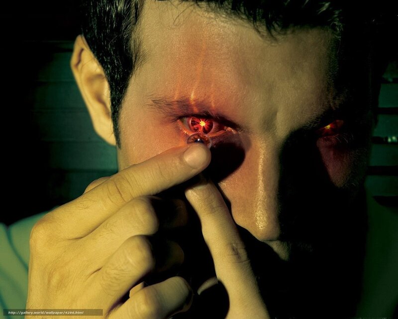 man inserting contact lens