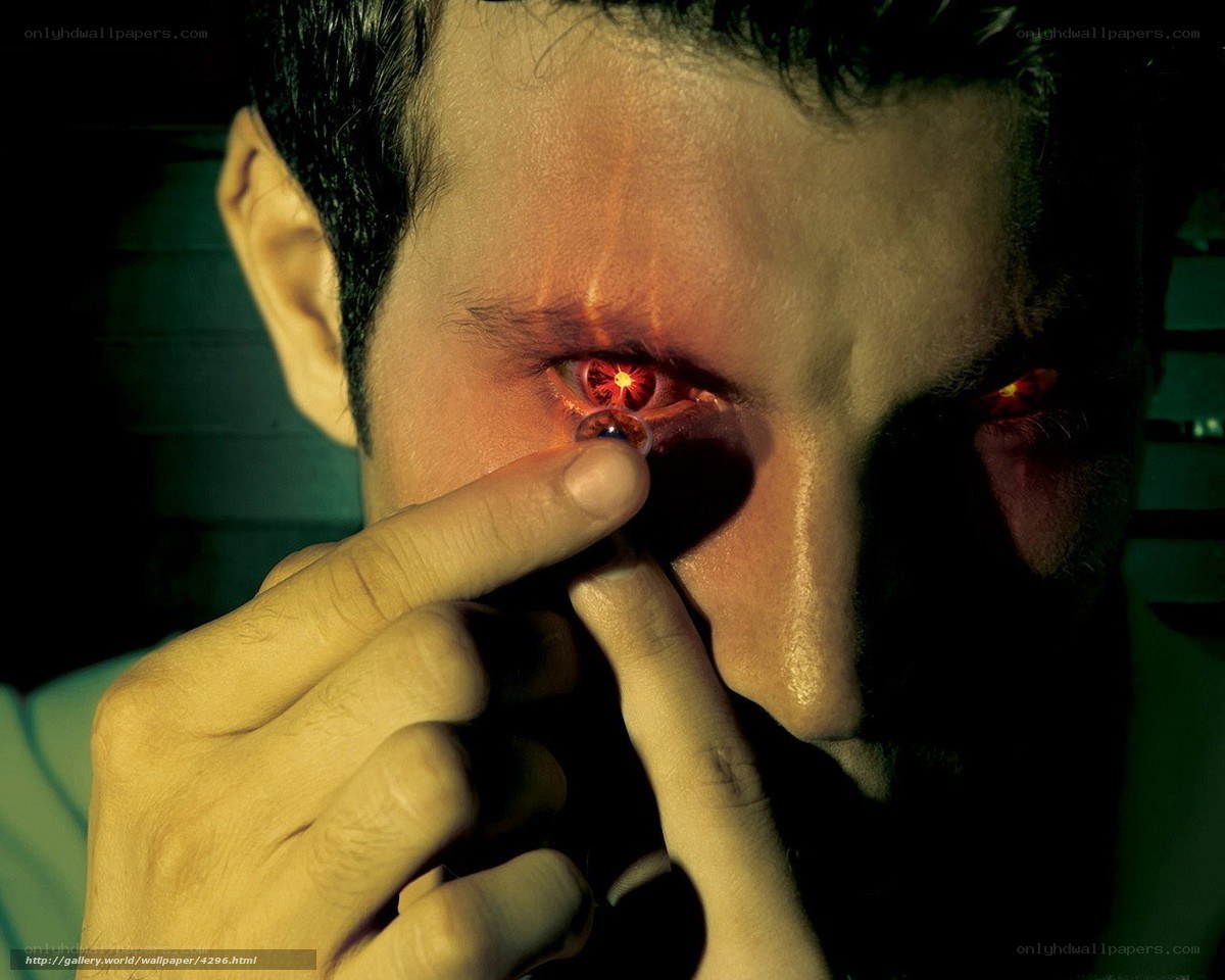 man inserting contact lens