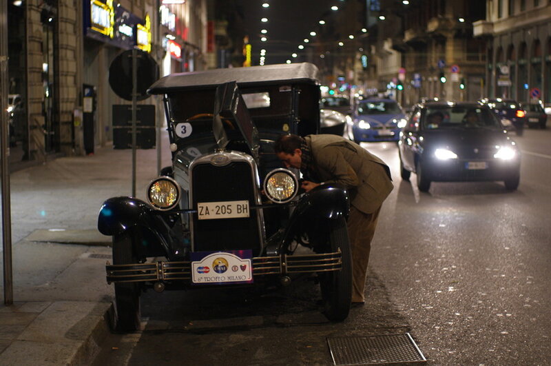 Man Inspecting Vintage Car