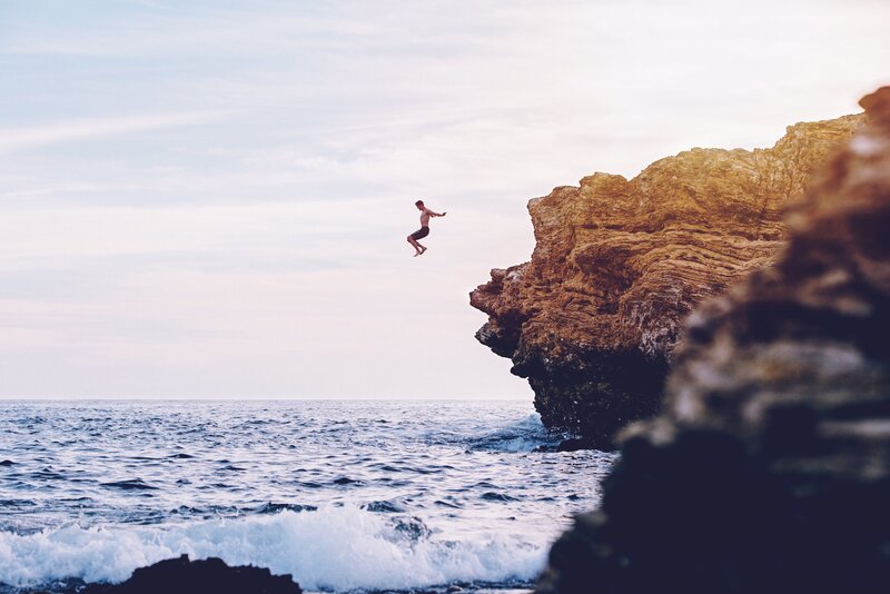 Man Jumping from Cliff — Blue