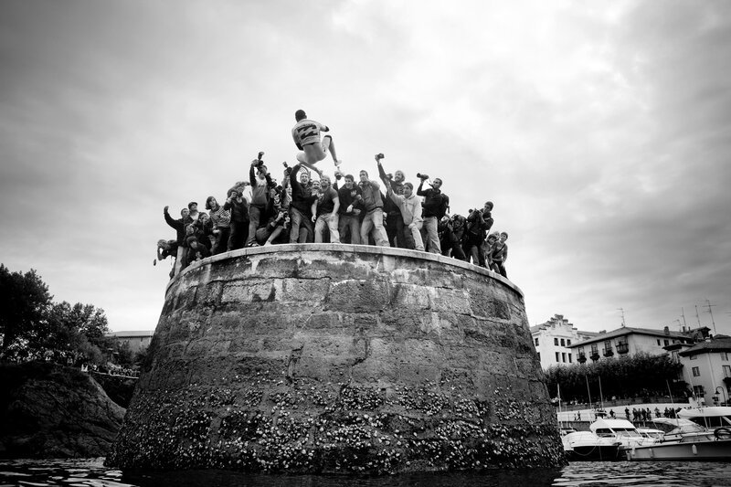 Man jumping from stone pillar