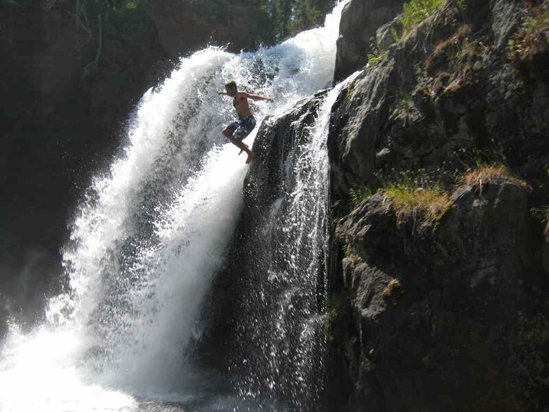 Man Jumping from Waterfall