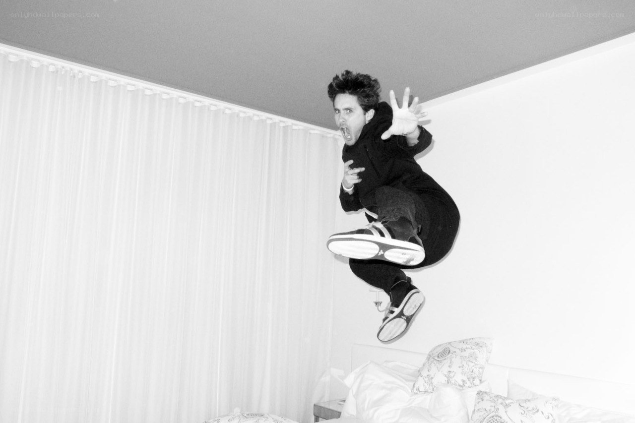 Man jumping on a bed