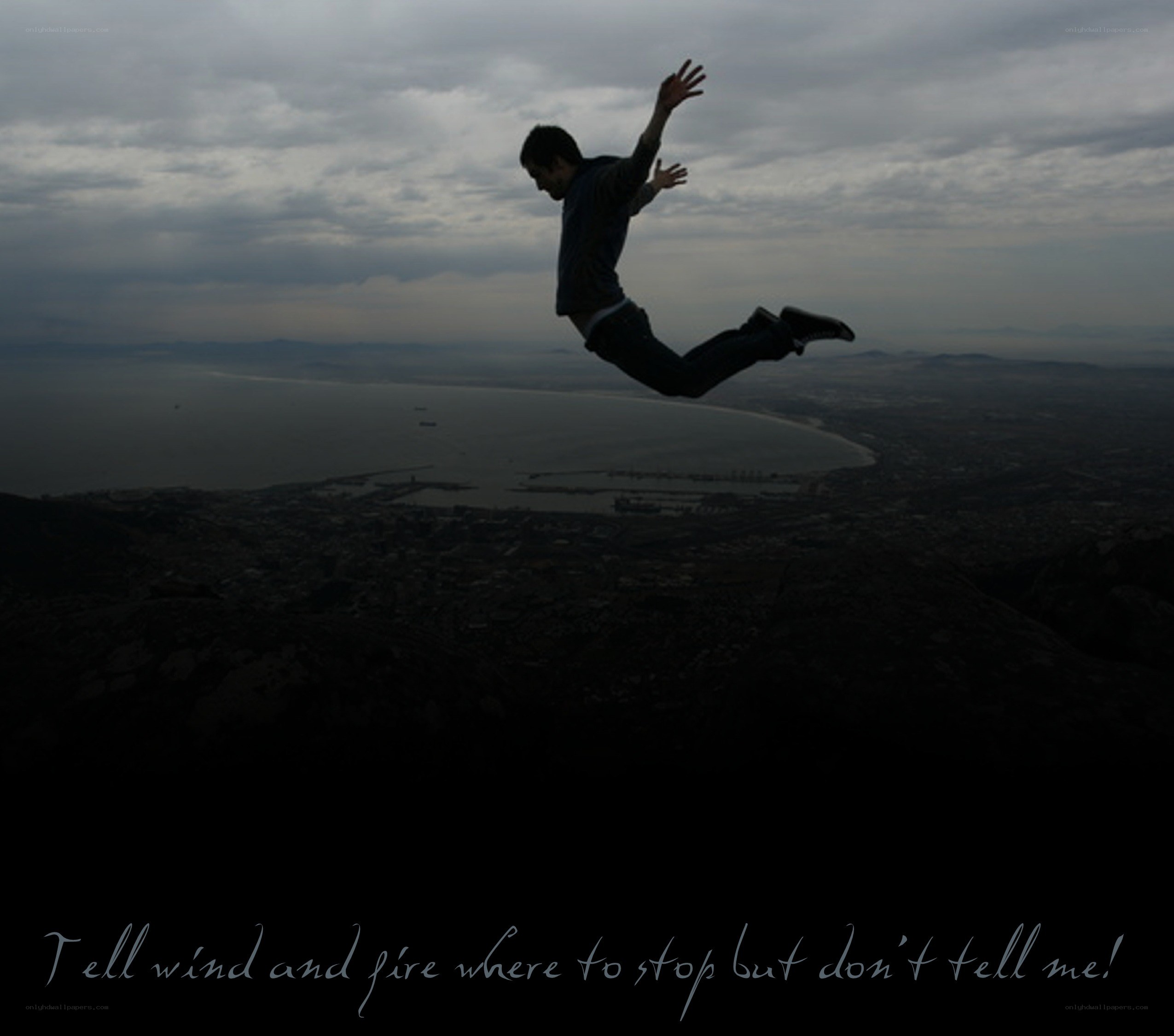 man jumping on cliff