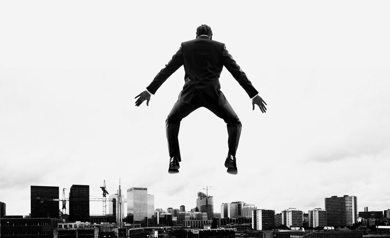 man jumping over city