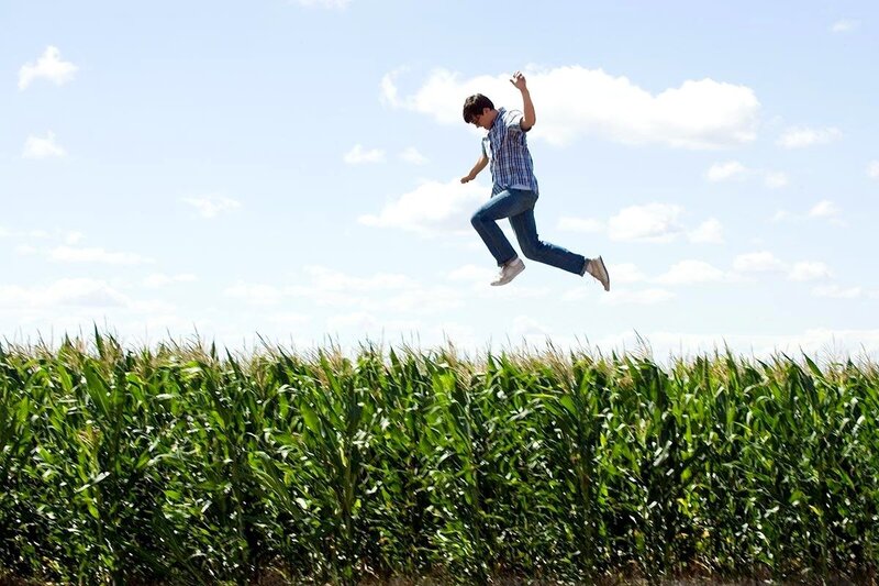Man jumping over cornfield
