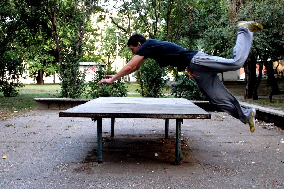man jumping over table