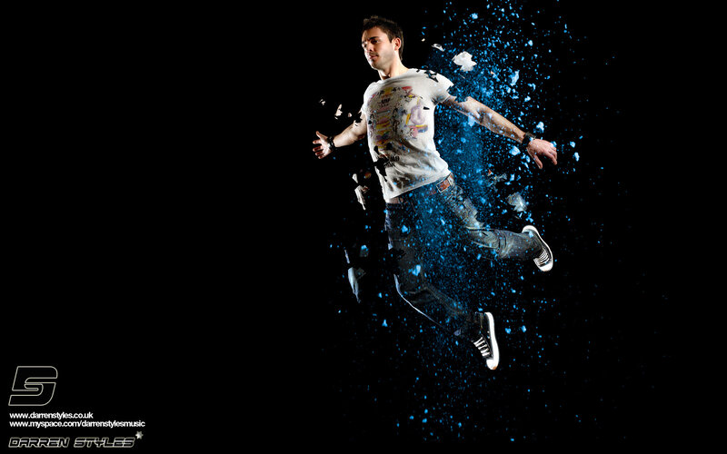 man jumping through blue particles