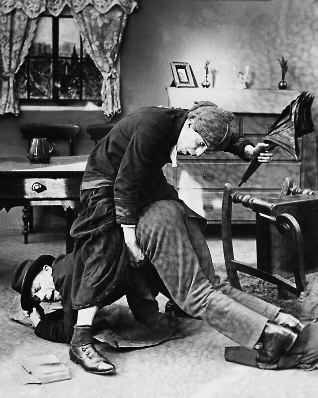 Man kicking another man on the floor