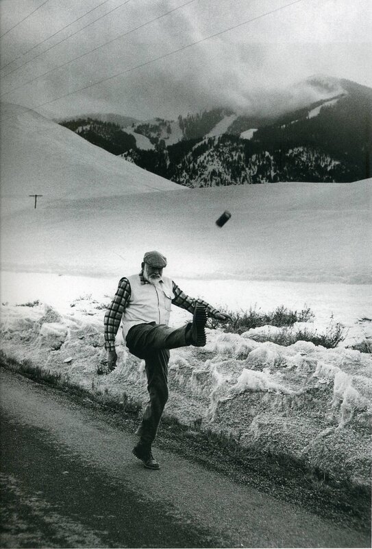 Man kicking can in snowy landscape