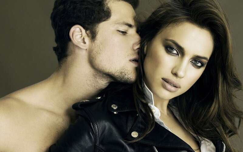 man kissing woman's neck