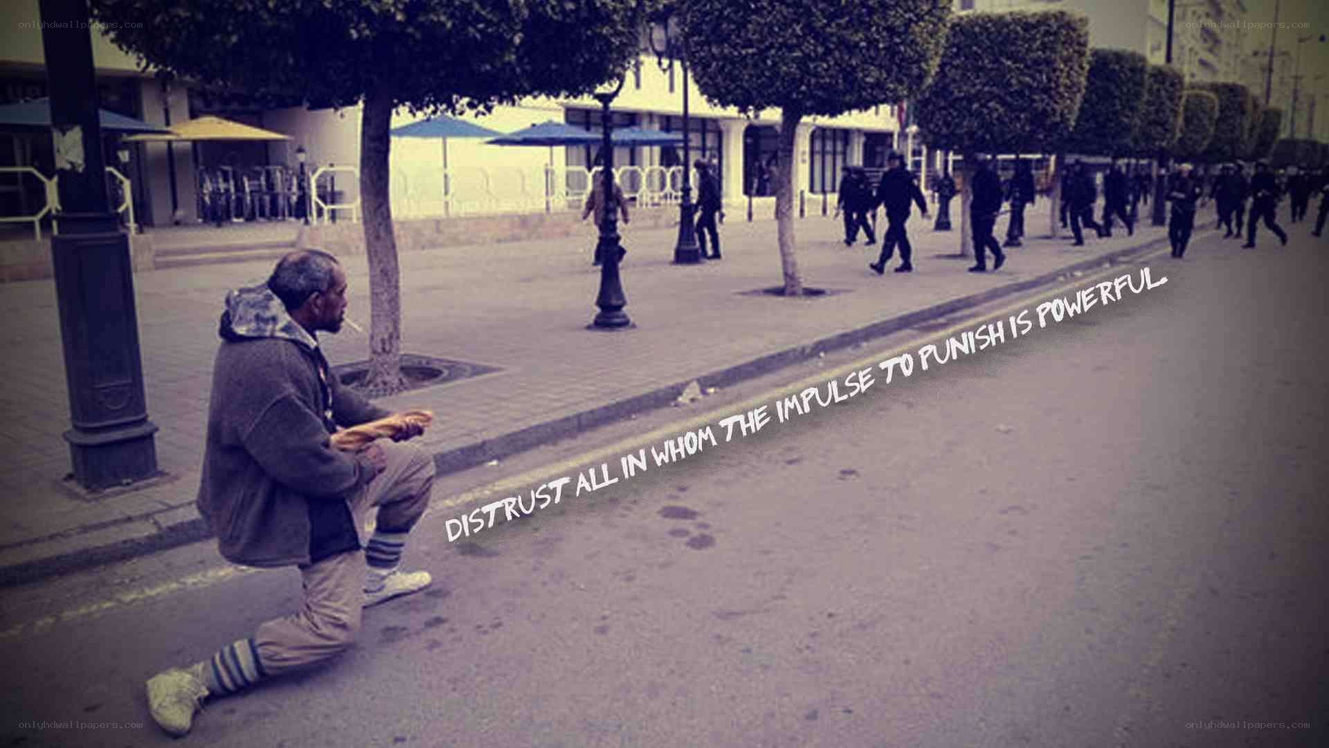 Man kneeling on street