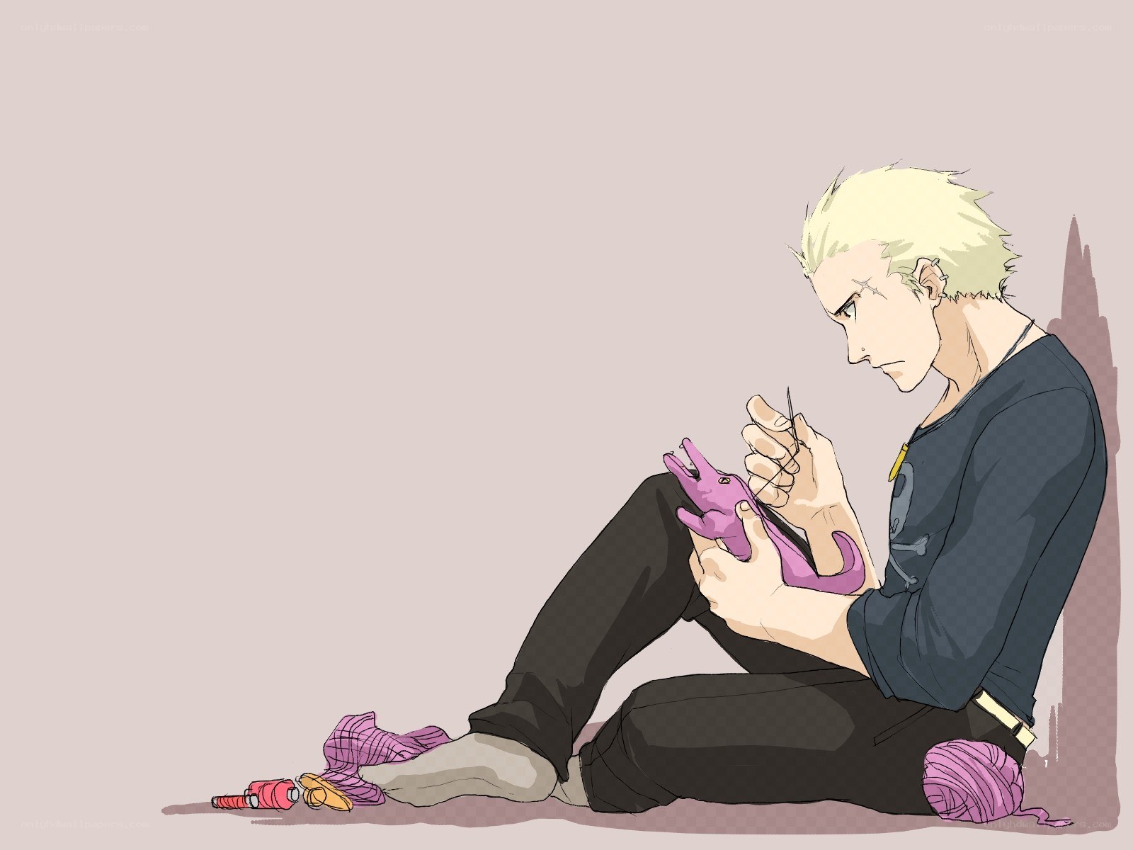 man knitting a plush toy
