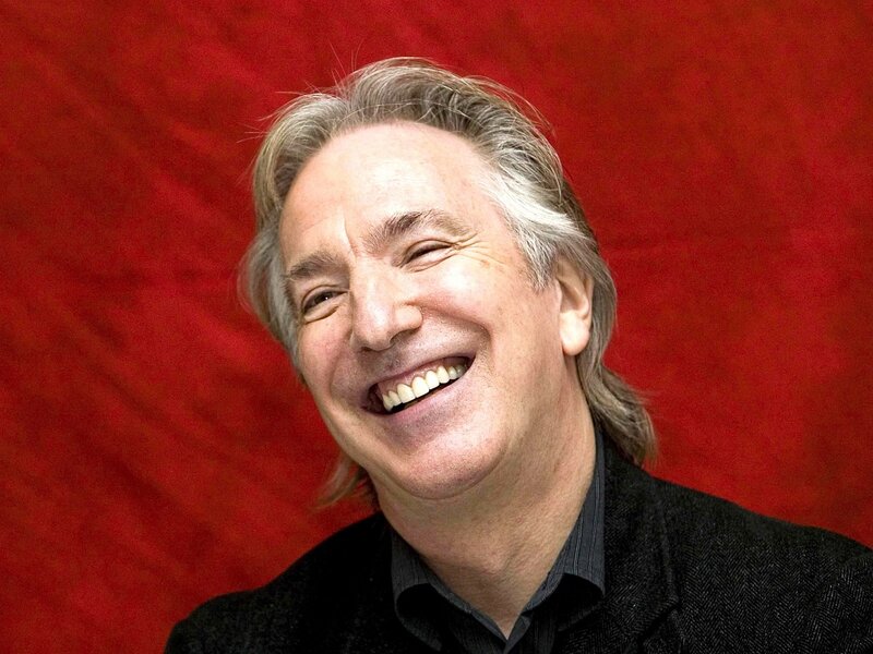 man laughing against red background
