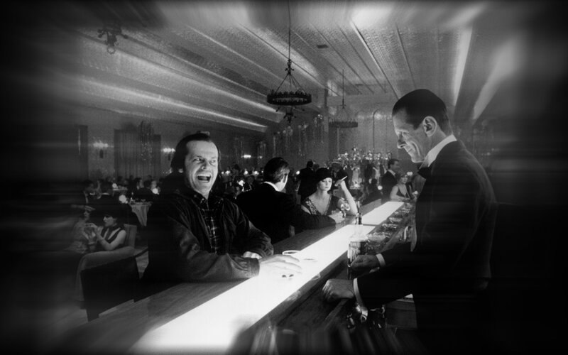 man laughing at bar